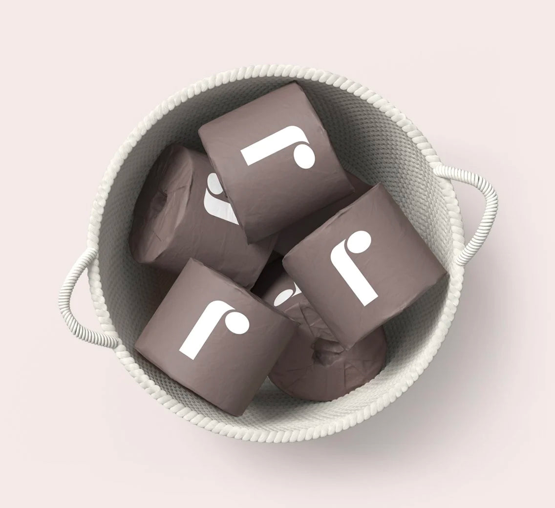 basket of Reel toilet paper in branded wrapping