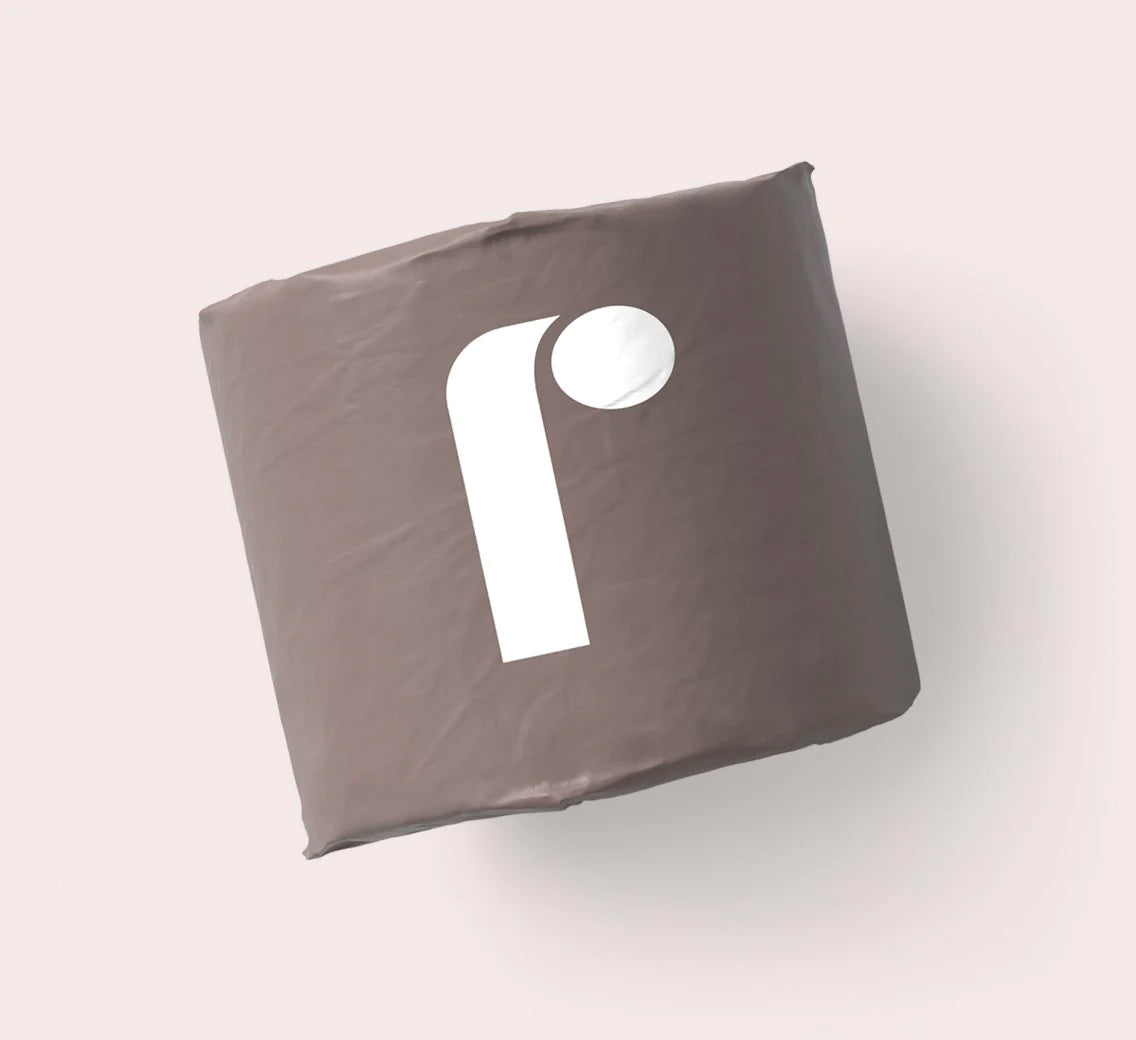 A roll of Reel toilet paper in branded wrapping