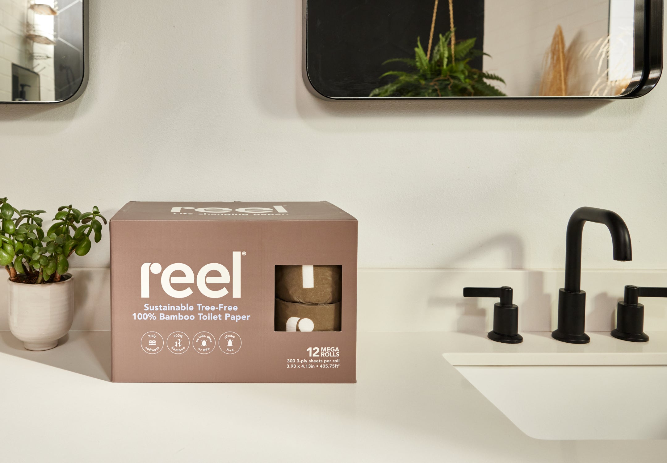 A box of Reel toilet paper sitting on a bathroom counter 